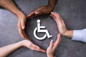 Close-up Of A Hands Protecting Disabled Handicap Icon